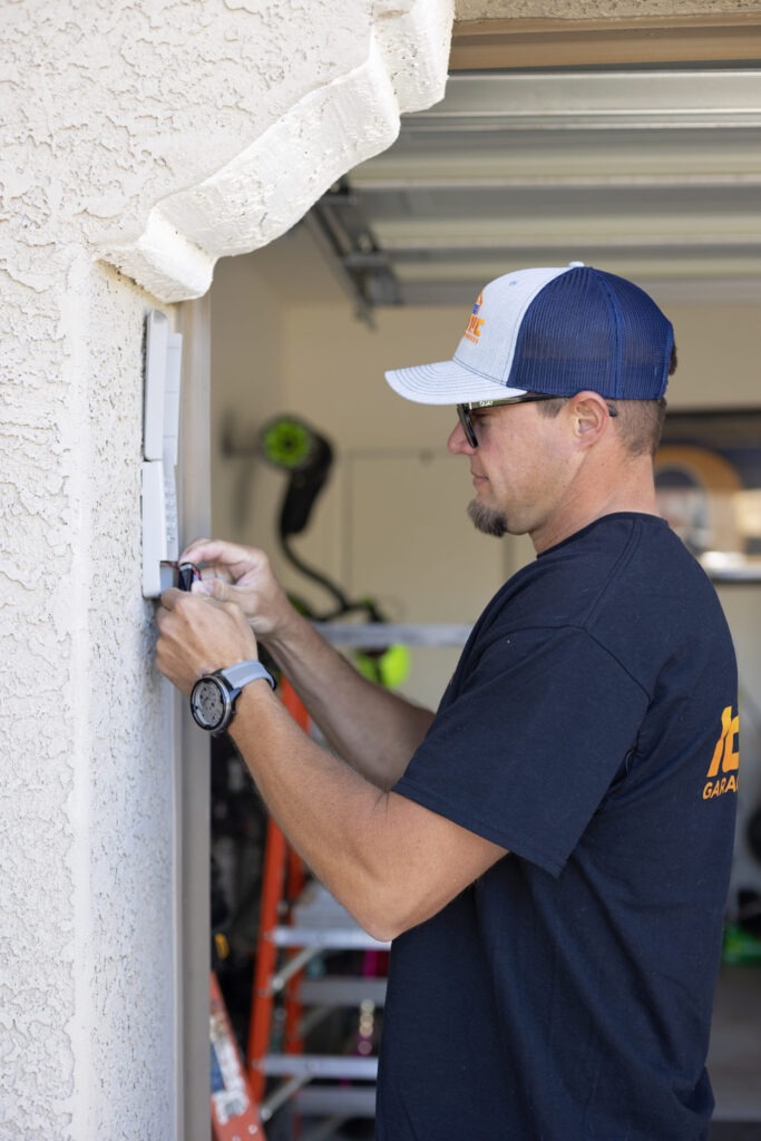 Iconic Garage Door Service technician programming new garage door keypad