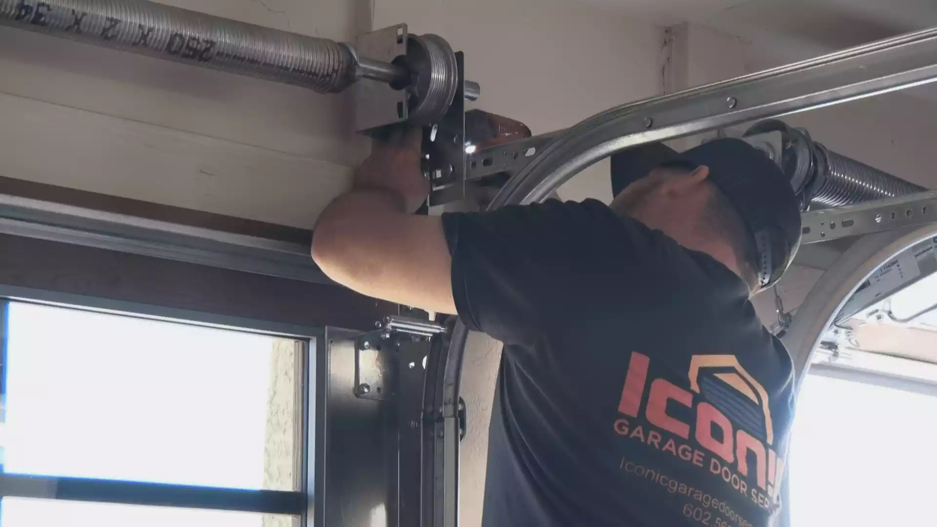 Iconic Garage Door Services repairman working on a garage door repair