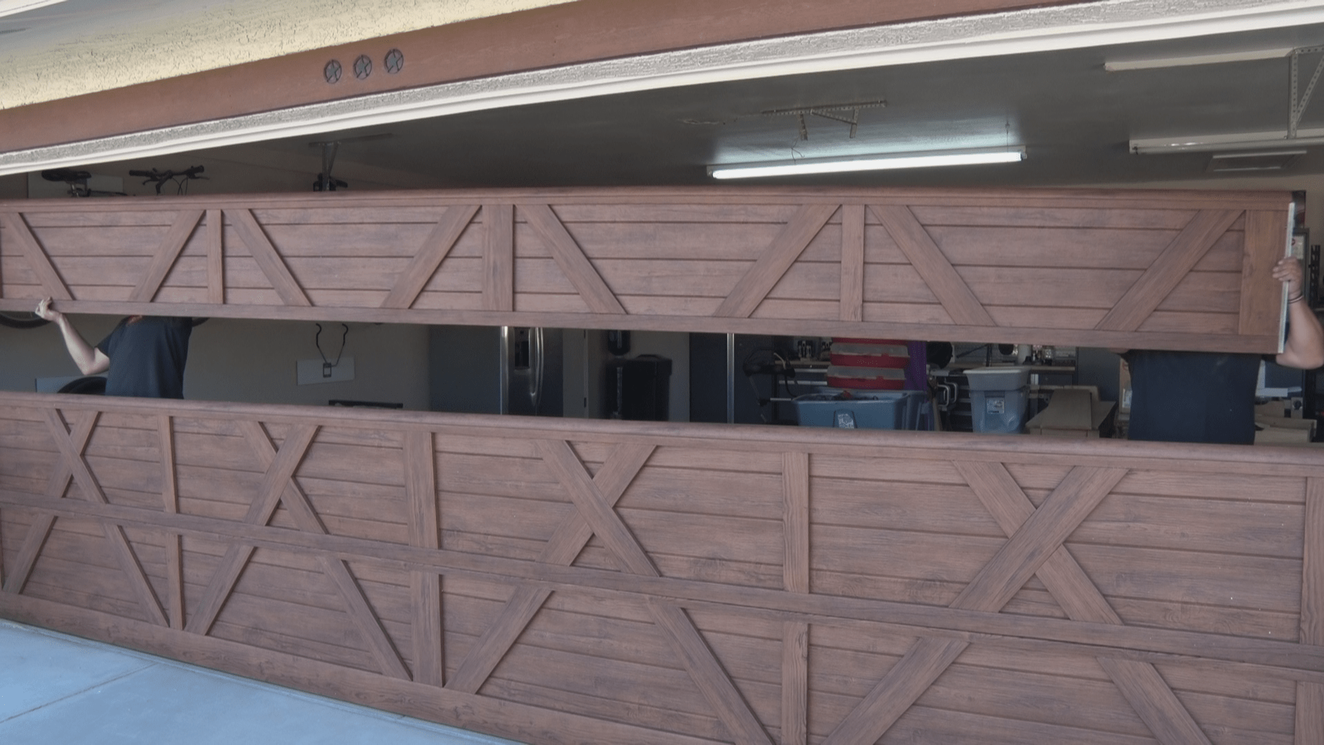 Carriage garage door with an overlay beign installed by Iconic Garage Door Service
