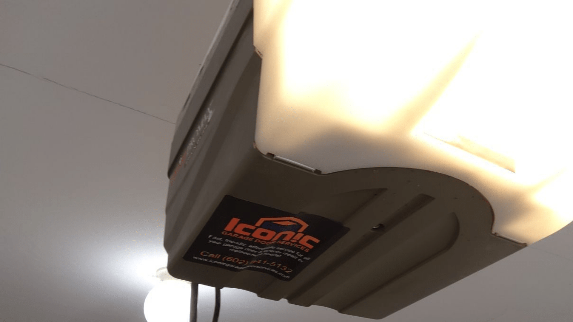 Garage door opener with Iconic Garage Door Services sticker