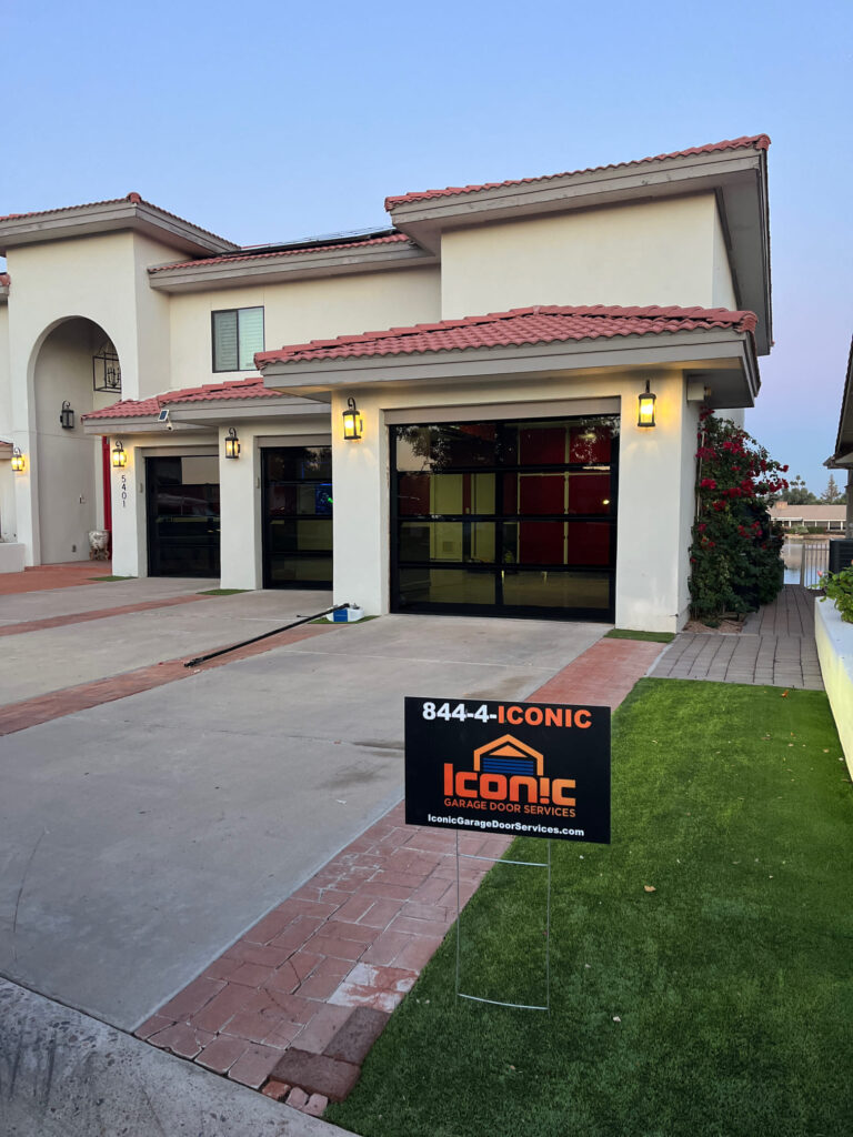 Iconic Garage Door Services Installing a New Full-View Glass Garage Door